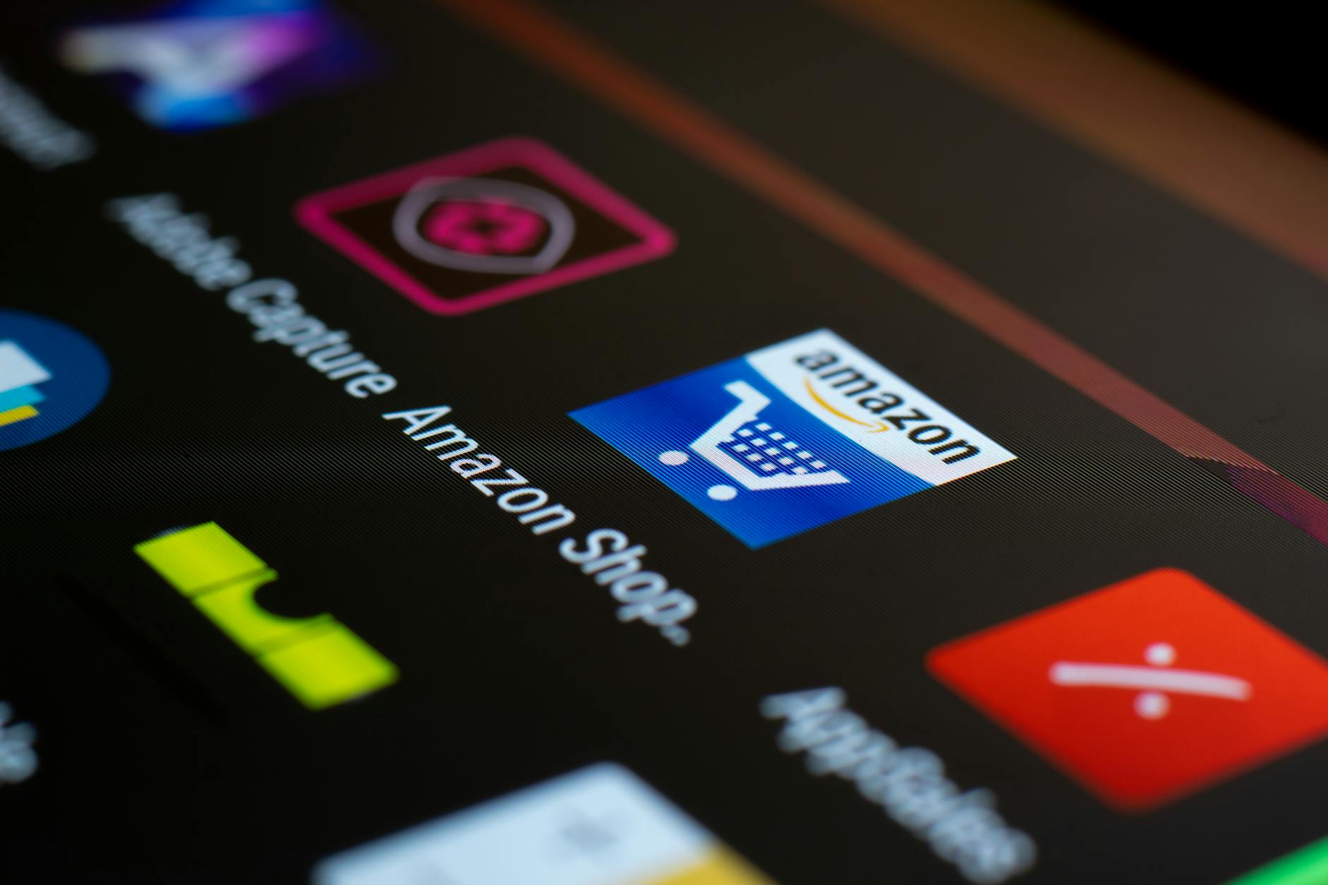 close up of smartphone screen with icons, showing Amazon app